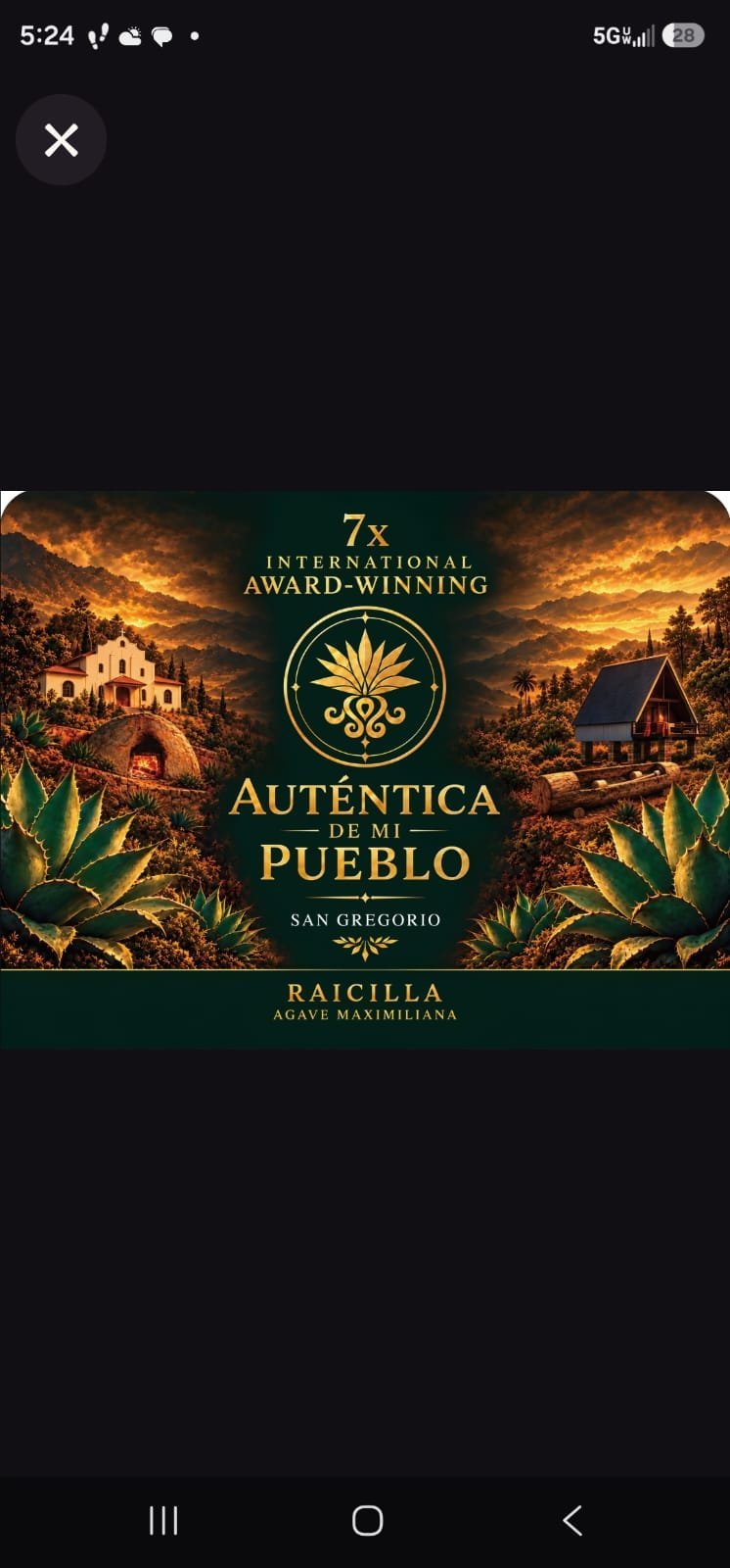 Autentica de mi Pueblo mezcal bottle label featuring a golden emblem, rustic Mexican buildings, and agave plants against a dramatic sunset background